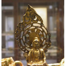 Gilt-bronze seated figure of the Buddha, sun disc